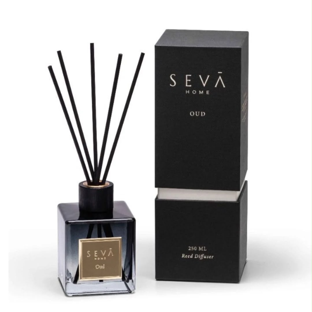 Reed diffuser beside its tall black gift box